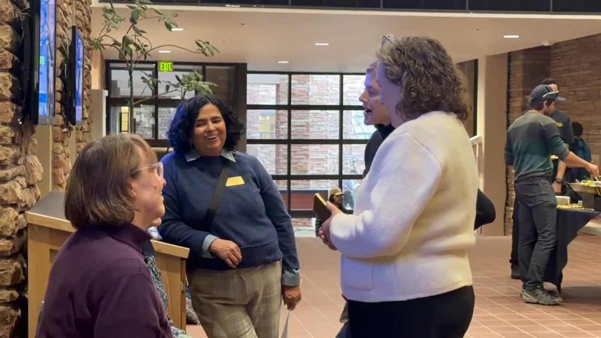 Faculty fellow networking at campus event