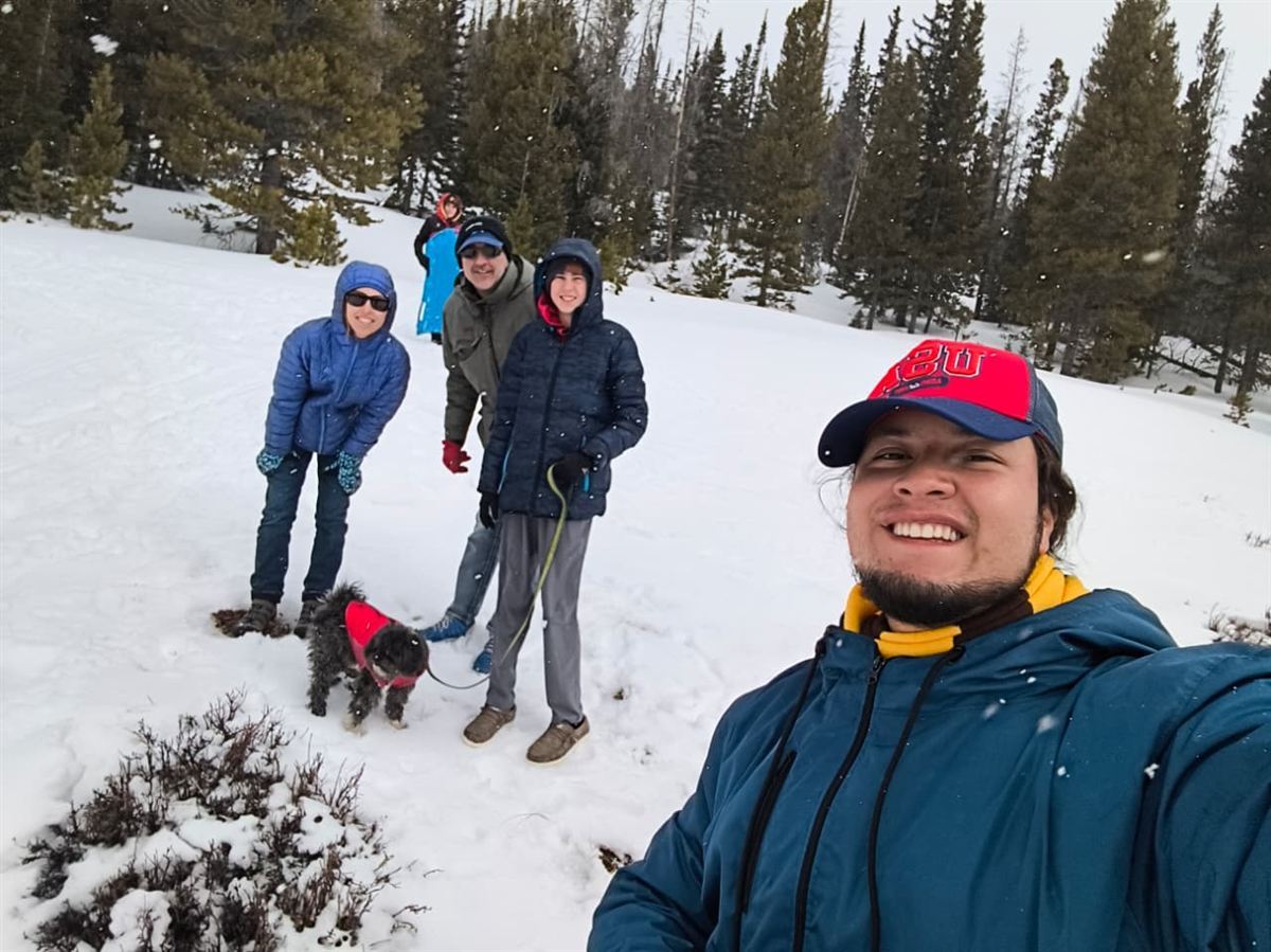 Participant with host family in the Wyoming mountains